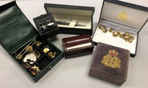 A box containing assorted cufflinks, studs, pen, knives,