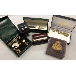 A box containing assorted cufflinks, studs, pen, knives,