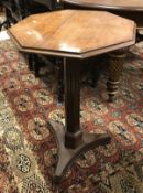 A 19th Century mahogany pedestal occasional table the octagonal top with moulded edge on a fluted