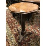 A 19th Century mahogany pedestal occasional table the octagonal top with moulded edge on a fluted