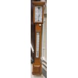 A Victorian oak stick barometer, the dial inscribed "Spridion & Son, Opticians,
