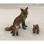 A cold painted bronze study of a fox in the Vienna manner together with two cubs
