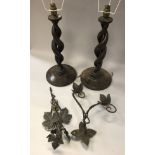 A pair of early 20th Century oak barley twist table lamps together with a pair of wrought iron and