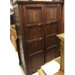 An early 20th Century oak two door wardrobe in the Arts & Crafts taste