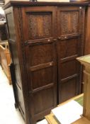 An early 20th Century oak two door wardrobe in the Arts & Crafts taste