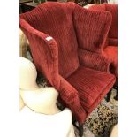 A 19th Century red upholstered wing back chair with shell carved cabriole front legs to ball and