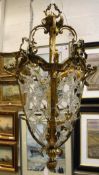 A 20th Century lacquered brass and glass bead latticework decorated ceiling light in the 19th
