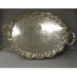 A large silver plated tray in the Rococo taste with all-over scrolling foliate engraved and cast