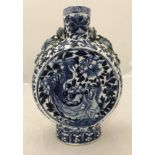 An early 20th Century Chinese blue and white moon flask with relief work dragon handles,