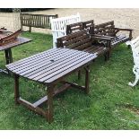 A pair of modern slatted wooden garden benches together with two matching garden chairs and similar