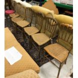 A set of six gold painted can seated chairs,