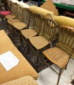 A set of six gold painted can seated chairs,