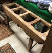 A Chinese pine side table/stand with slatted top above a shaped apron on square supports