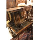 An Edwardian mahogany two drawer writing table on square tapered legs to castors,