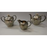 A circa 1900 Russian silver three piece teaset of ovoid form with engraved decoration of Moscow
