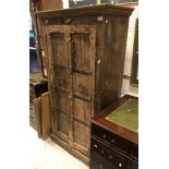 An Indonesian hardwood two door cupboard with wrought iron decoration