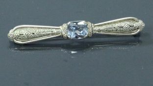 A silver and aquamarine Art Deco style brooch of ribbon form