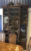 A 20th Century mahogany breakfront bookcase cabinet in the Chippendale manner