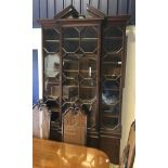 A 20th Century mahogany breakfront bookcase cabinet in the Chippendale manner