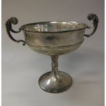 A George V silver trophy cup with two scrollwork handles,