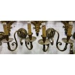 A pair of brass twin light wall sconces with serpent head decoration together with two pairs of