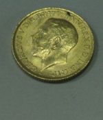 A George V gold sovereign,