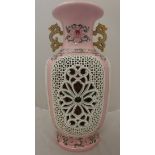 A modern Chinese famille-rose reticulated vase with internal flower head decoration