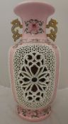 A modern Chinese famille-rose reticulated vase with internal flower head decoration