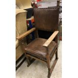 An early 20th Century oak framed hall chair in the 17th Century manner with studded leather