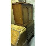 An early 20th Century mahogany bedroom cabinet with two cupboard doors enclosing shelf and two