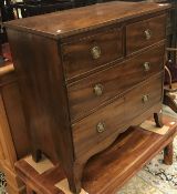 An early 19th Century mahogany chest of two short over two long drawers on splayed bracket feet