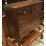 An early 19th Century mahogany chest of two short over two long drawers on splayed bracket feet