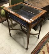 An Edwardian mahogany and satinwood cross banded bijouterie table on square tapered legs united by
