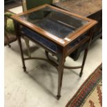 An Edwardian mahogany and satinwood cross banded bijouterie table on square tapered legs united by