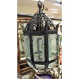 A modern black painted wrought iron and glass ceiling lantern,