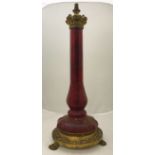 A Victorian gilt brass and ruby glass table lamp of faceted baluster column form