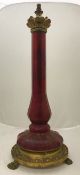 A Victorian gilt brass and ruby glass table lamp of faceted baluster column form