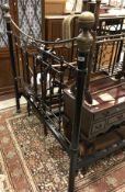 A wrought iron and brass bedstead in the Victorian manner