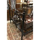 A wrought iron and brass bedstead in the Victorian manner