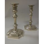 A pair of George V silver candlesticks in the early 18th Century manner,