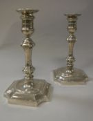 A pair of George V silver candlesticks in the early 18th Century manner,