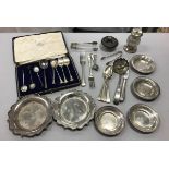 A collection of silver and Continental white metal to include a pair of pie crust coasters,