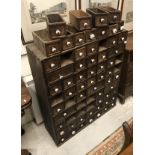 An Indonesian hardwood multi drawer spice chest each drawer with ceramic knob handle