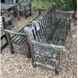 A pair of slatted teak garden benches