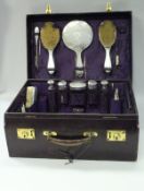 A Walker & Hall purple dyed leather ladies travelling vanity case with silver fittings,