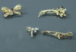 Four various gold and stone set brooches