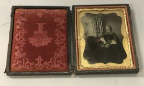 A Victorian daguerreotype depicting a lady seated,