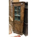 A 20th Century walnut corner cupboard in the 18th Century manner