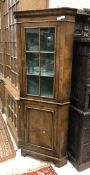 A 20th Century walnut corner cupboard in the 18th Century manner