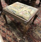 An 18th Century oak dressing stool with needlework drop in seat on cabriole legs to pad feet